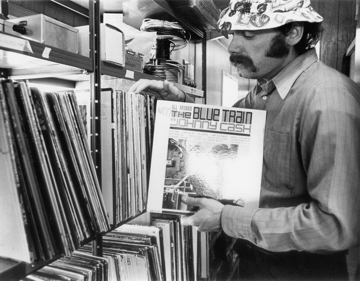 Carmine is pictured with the over 2,000 country-western albums and 3,500 45 rpm records he began with at WKKM.